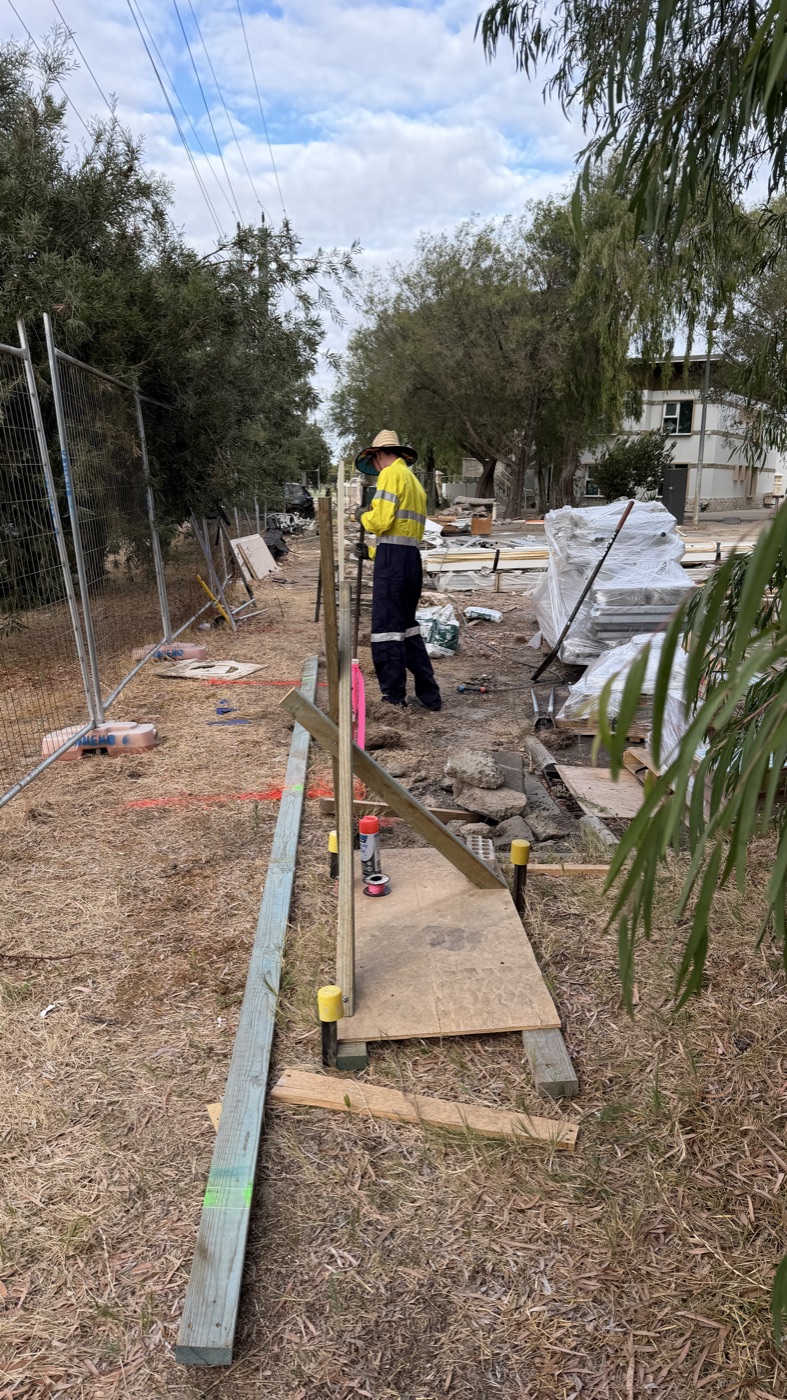 Togtuun worker in high-visibility clothing installing fencing on site