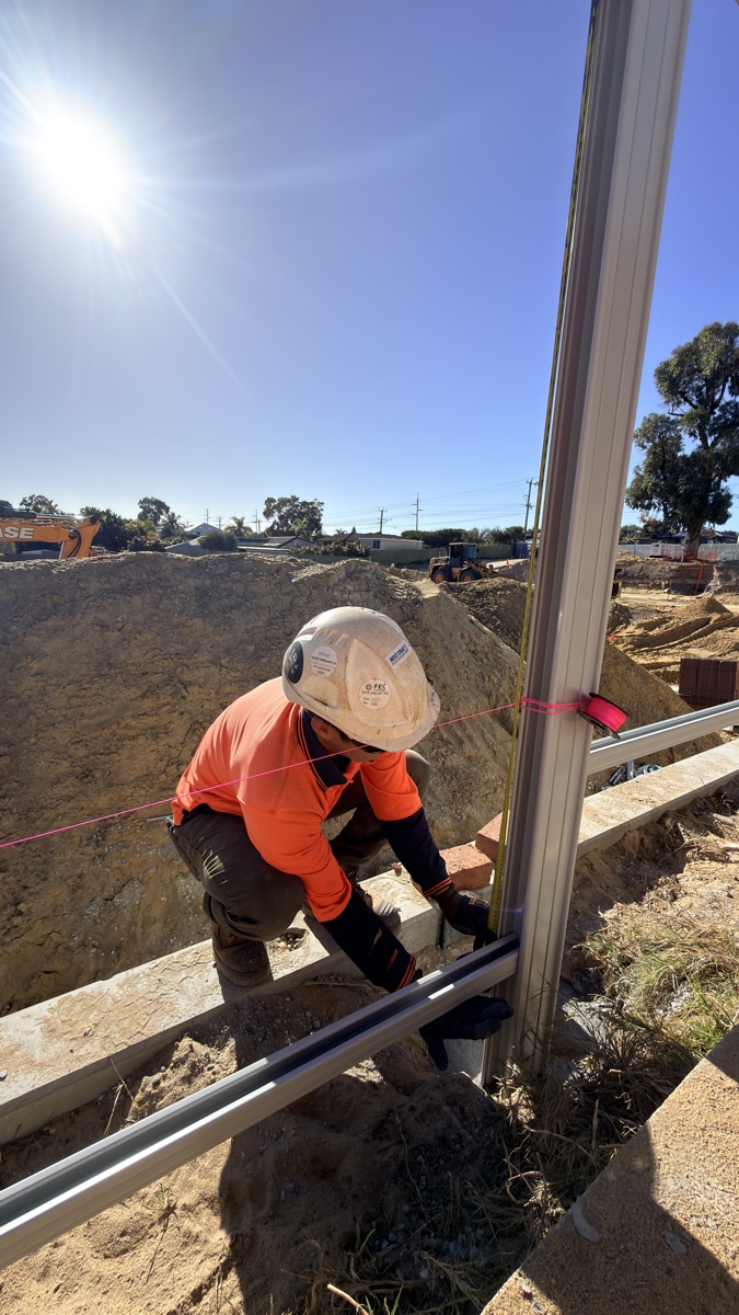 Togtuun crew member installing steel fence framing on site