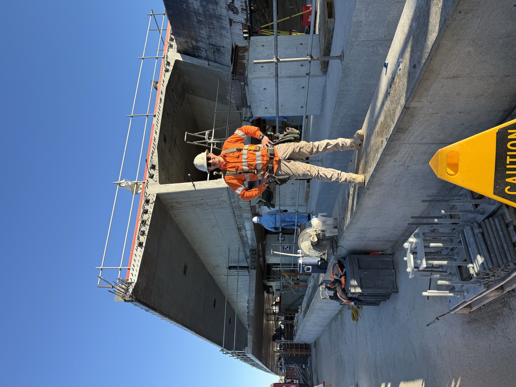 Togtuun crew member in full PPE standing on the completed Mandurah New Bridge structure