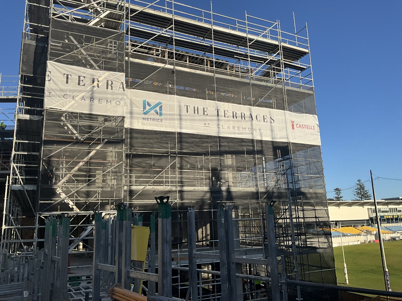 The Terraces at Claremont development under construction, scaffolded high-rise with tower crane